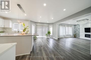Cambridge apartment for rent - A spacious kitchen with white cabinets and a wooden floor.