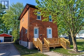 Orillia multi-family for rent - A brick house with a white door and a small porch.