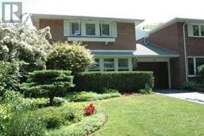 Toronto (L'amoreaux) apartment for rent - A house with a well-maintained lawn and garden in front.