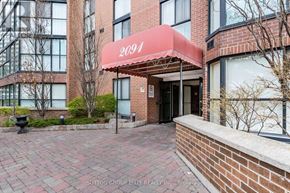 Mississauga (Cooksville) condo for rent - The image shows a building entrance with a red awning and the number 2091 on it.