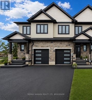 Niagara Falls (Forestview) townhouse for rent - A large, two-story house with a black garage door is shown.