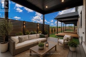 Niagara Falls (Forestview) townhouse for rent - A patio with a couch, table, and chairs is shown.