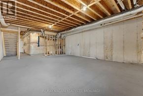 Niagara Falls (Forestview) townhouse for rent - A large empty room with wooden ceiling and walls under construction.