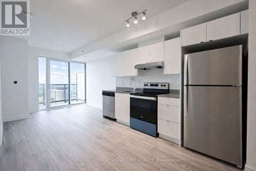 Burlington (Alton) condo for rent - A modern kitchen with stainless steel appliances and wooden flooring.