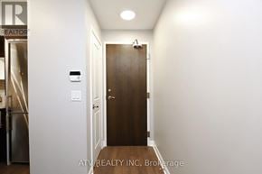 Toronto (Islington-City Centre West) condo for rent - A hallway with a door and a sign that says "ATVREALTY INC. Brokerage".