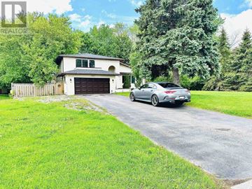 Oshawa (Kedron) apartment for rent - A car is parked in front of a house with a garage.