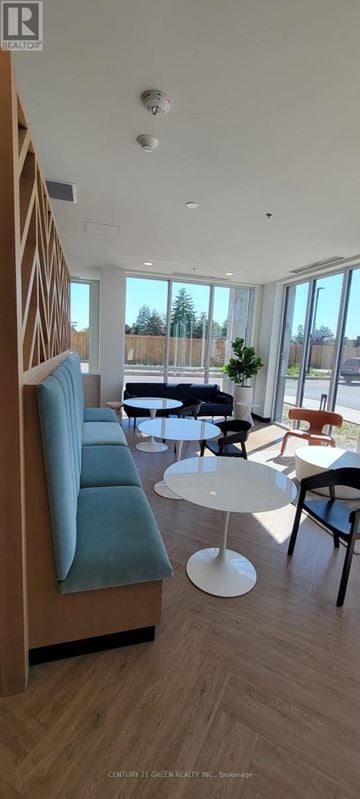 Kitchener condo for rent - A modern living room with a blue sofa and a white coffee table.