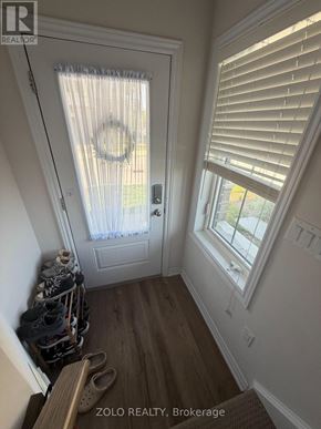 Cambridge townhouse for rent - A hallway with a door and a window with blinds.