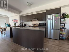 Cambridge townhouse for rent - A kitchen with a refrigerator covered in magnets.
