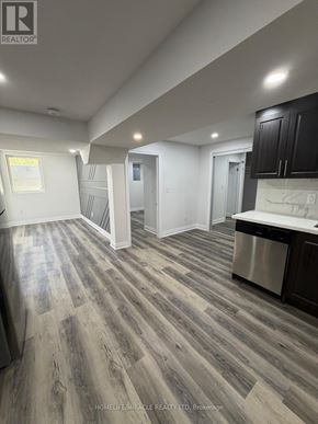Oshawa (Eastdale) apartment for rent - A kitchen with a stainless steel dishwasher and dark wood flooring.
