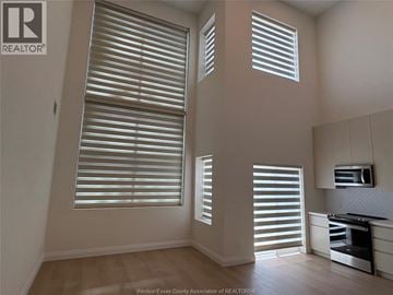 Lasalle townhouse for rent - A kitchen with a microwave and a stove top oven.