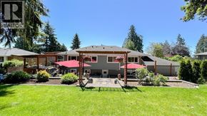 West Vancouver apartment for rent - A house with a red roof and a garden in front.