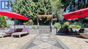 West Vancouver apartment for rent - A gazebo is surrounded by benches and umbrellas in a landscaped area.