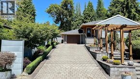 West Vancouver apartment for rent - A house with a grey roof and a wooden pergola.