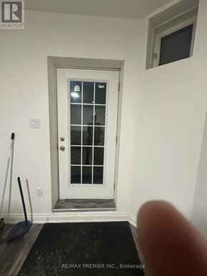 Mississauga (Churchill Meadows) apartment for rent - A white door with a glass window and a black broom leaning against the wall.