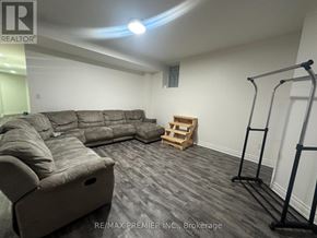Mississauga (Churchill Meadows) apartment for rent - A grey sectional sofa in a room with a pull up bar.