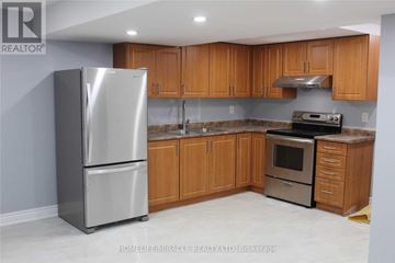 Brampton (Fletcher's Meadow) apartment for rent - A kitchen with wooden cabinets and a stainless steel refrigerator.
