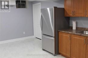 Brampton (Fletcher's Meadow) apartment for rent - A silver refrigerator is in a kitchen with wooden cabinets.