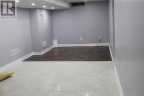 Brampton (Fletcher's Meadow) apartment for rent - A room with grey walls and a wooden floor.