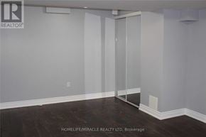 Brampton (Fletcher's Meadow) apartment for rent - A room with a sliding glass door and wooden flooring.