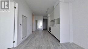 Toronto (Newtonbrook East) condo for rent - A long, narrow hallway with white walls and a wooden floor.
