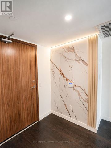 Toronto (Waterfront Communities) condo for rent - A room with a wooden door and marble wall.