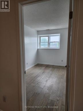 Cobourg apartment for rent - A room with a window and wooden flooring.