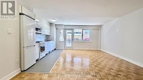 Toronto (Yonge-St. Clair) condo for rent - A kitchen with white appliances and wooden floors.