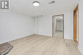 Halton Hills (Georgetown) apartment for rent - A white room with a wooden floor and a mirror on the wall.