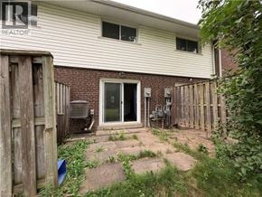 Waterloo townhouse for rent - A house with a backyard and a fence.