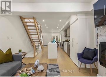 Toronto (Greenwood-Coxwell) apartment for rent - A living room with a grey couch and a wooden coffee table.