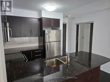 Richmond Hill (Langstaff) condo for rent - A kitchen with a black granite countertop and stainless steel appliances.