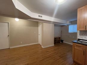 Delta apartment for rent - A kitchen with wooden floors and a countertop.