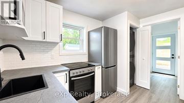 Belleville (Belleville Ward) apartment for rent - A kitchen with white cabinets and a black countertop.