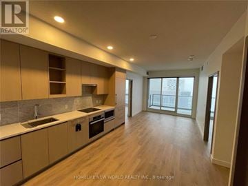Toronto (Bayview Village) condo for rent - A kitchen with wooden floors and beige cabinets.