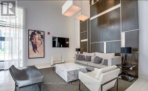 Mississauga (Creditview) condo for rent - A living room with a white couch, a grey chair, and a painting on the wall.