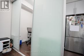 Mississauga (Creditview) condo for rent - A kitchen with a refrigerator covered in magnets and a white door.