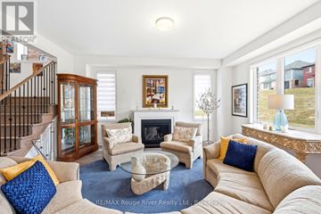 Cobourg apartment for rent - A living room with a fireplace and a painting on the wall.