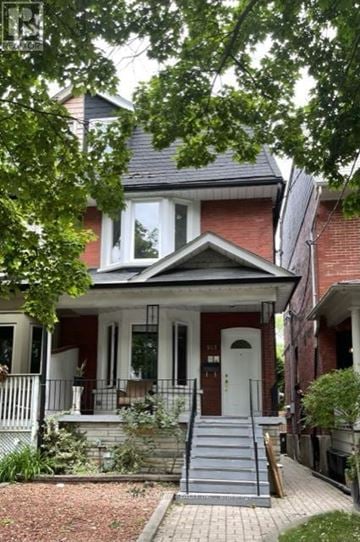 Toronto (Annex) apartment for rent - A house with a red brick exterior and a white door.