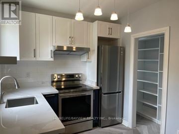 Toronto (Annex) apartment for rent - A kitchen with white cabinets and stainless steel appliances.