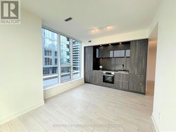 Toronto (Waterfront Communities) condo for rent - A spacious living room with a television and entertainment center.