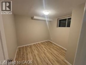 Kitchener apartment for rent - A room with wooden flooring and a window.