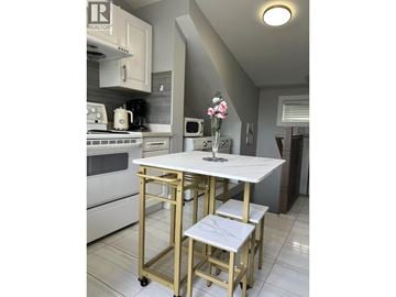 Vancouver apartment for rent - A kitchen with a white table and chairs.