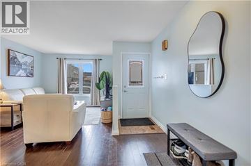 Hamilton apartment for rent - A living room with a white couch and a wooden floor.