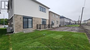 Clarington (Courtice) apartment for rent - A house with a lawn in front of it.