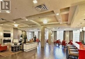 Toronto (Etobicoke West Mall) condo for rent - A spacious living room with a fireplace and a dining area.