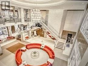 Toronto (Etobicoke West Mall) condo for rent - A large white circular room with a red circular table in the middle.