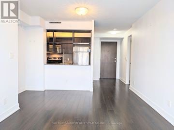 Toronto (Etobicoke West Mall) condo for rent - A spacious kitchen with white cabinets and a stainless steel refrigerator.