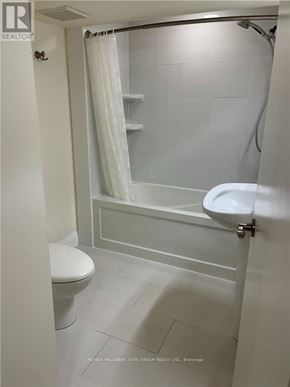 Toronto (Corso Italia-Davenport) apartment for rent - A white bathroom with a toilet, sink, and shower.