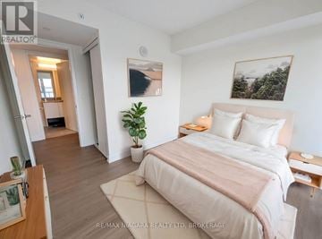Burlington (Lasalle) condo for rent - A bedroom with a large bed and a plant on the side table.